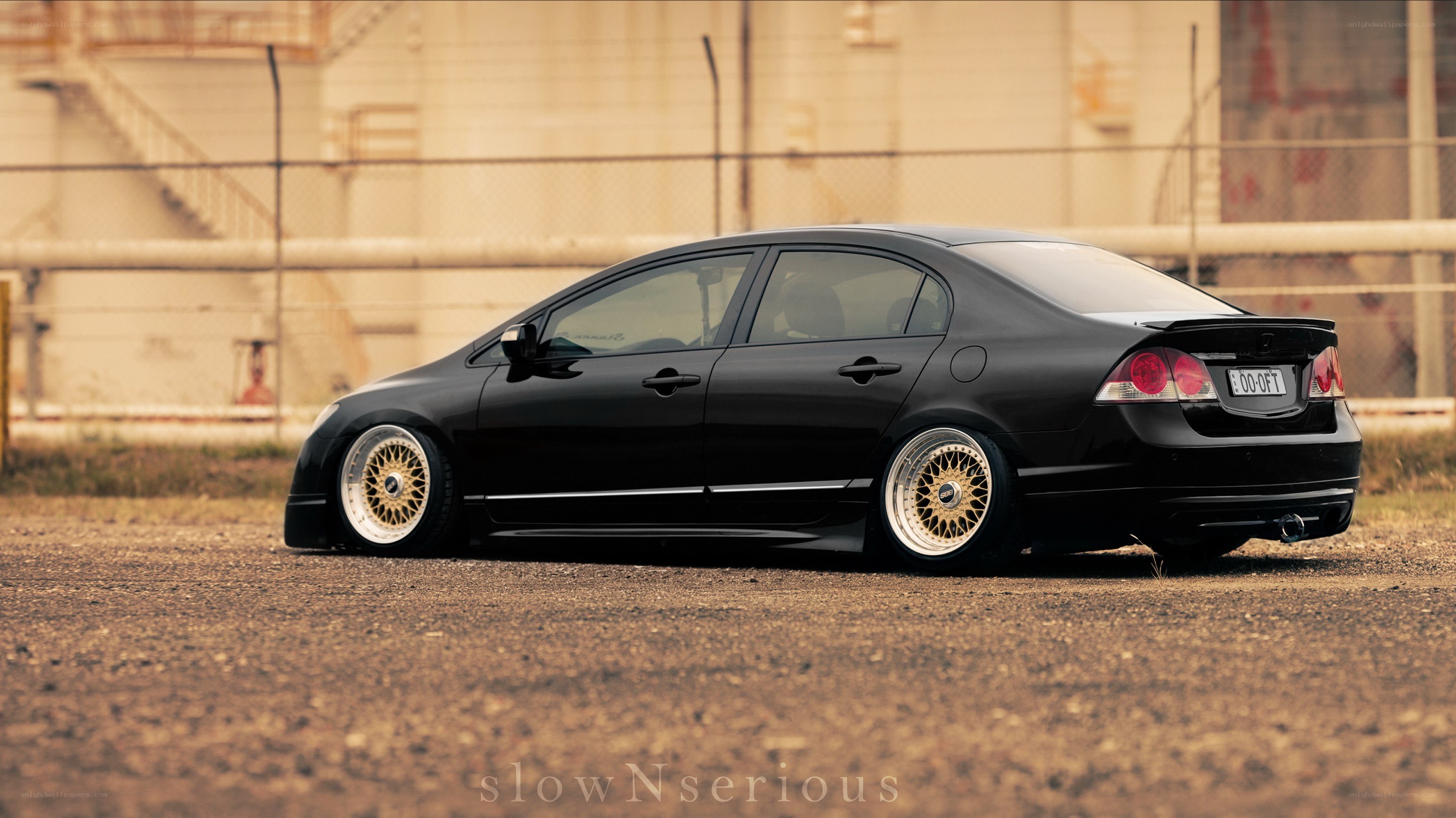 black sedan with gold wheels
