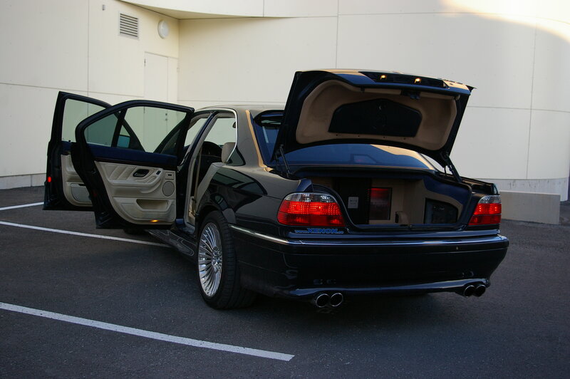black sedan with open doors