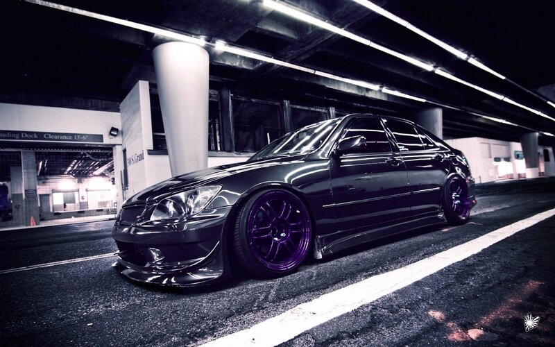 black sedan with purple wheels