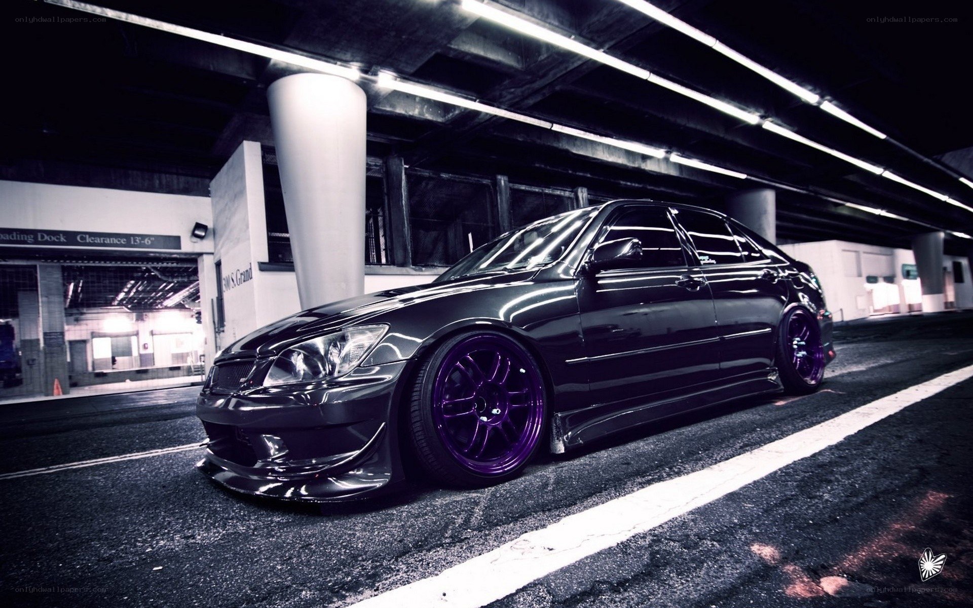black sedan with purple wheels