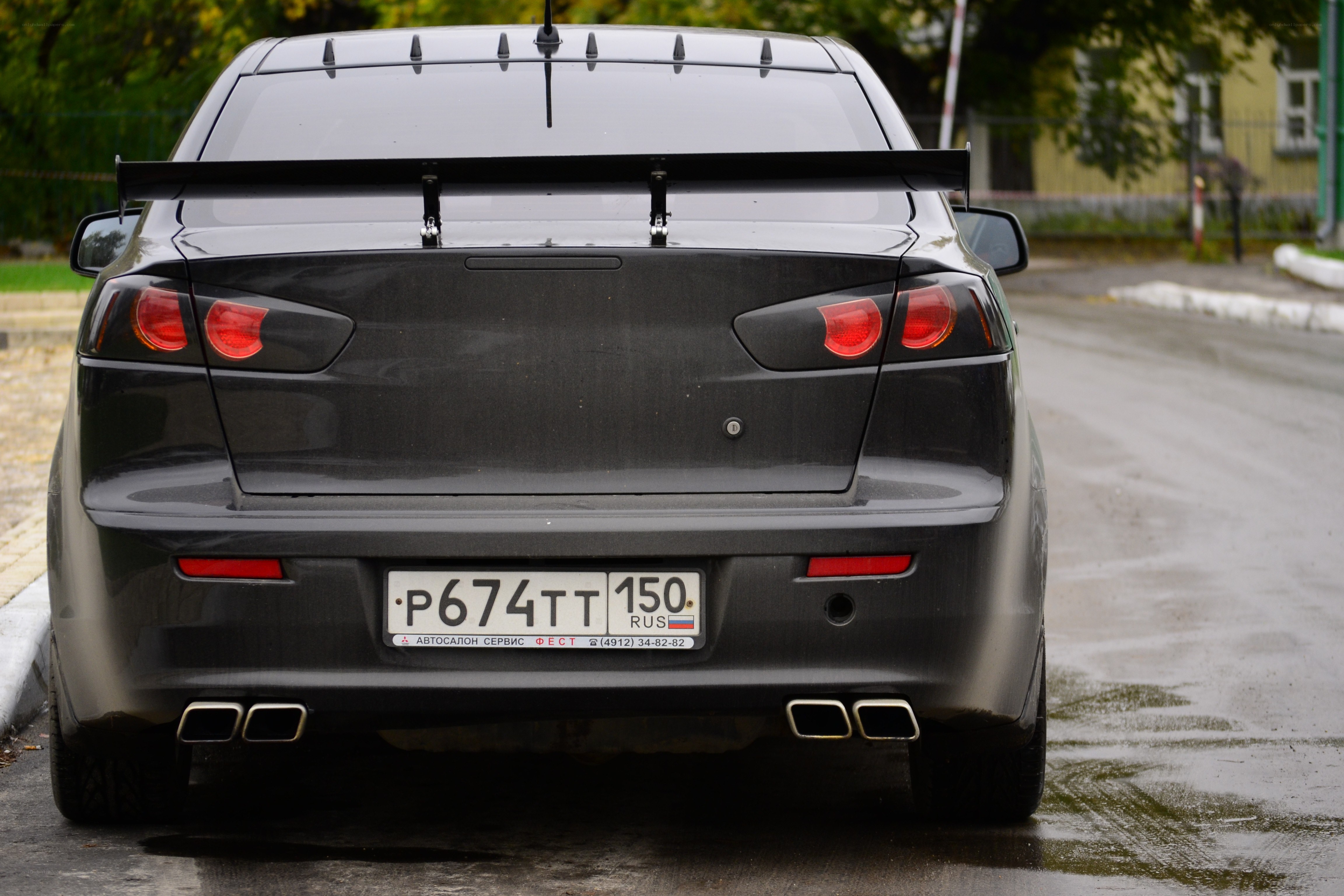 black sedan with rear spoiler