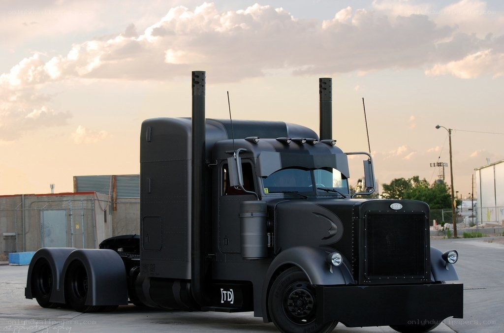 black semi-truck at sunset