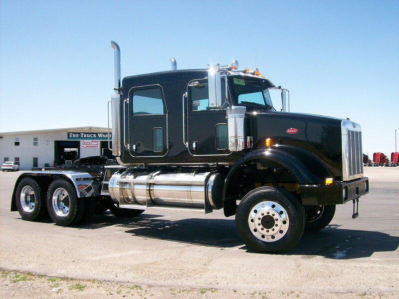 black semi-truck in parking lot
