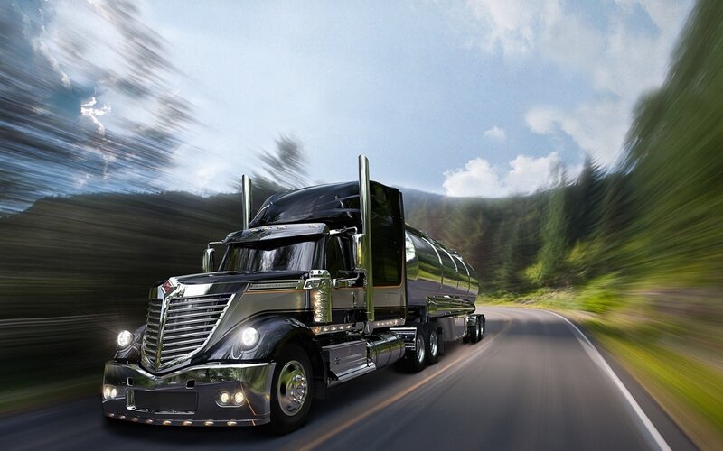 Black semi-truck on a highway