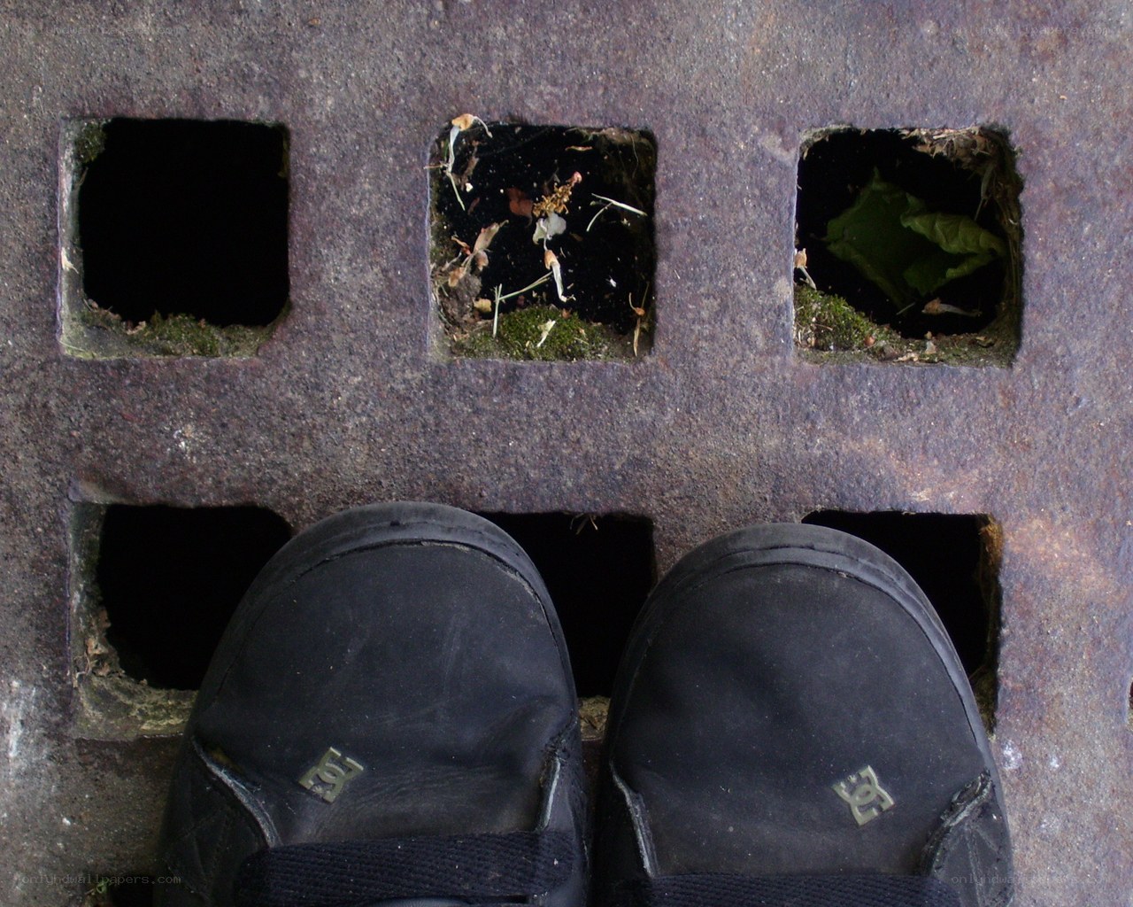 black shoes on a metal grate