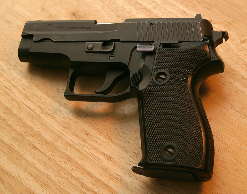 Black SIG Sauer pistol on wood