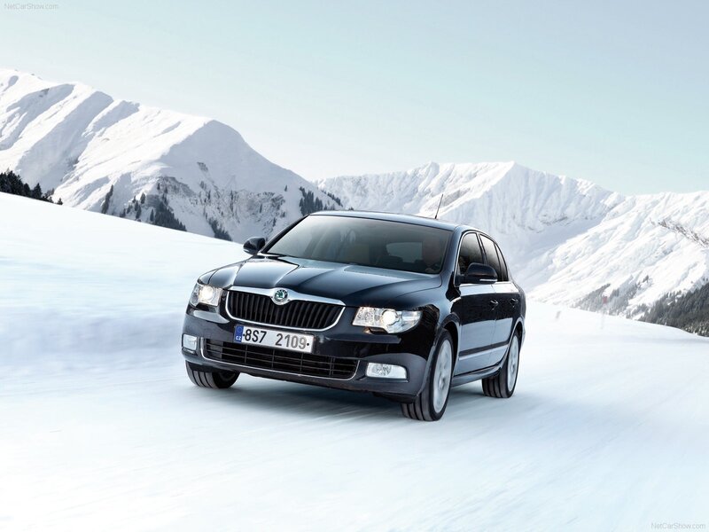 Black Skoda Octavia on snowy mountain road