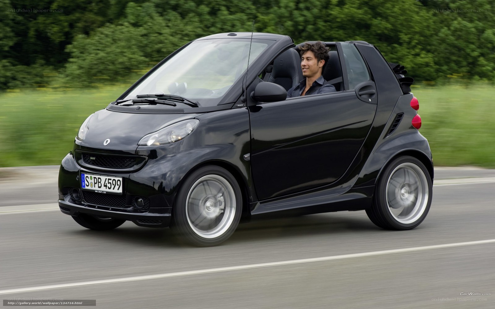black smart car driving on road
