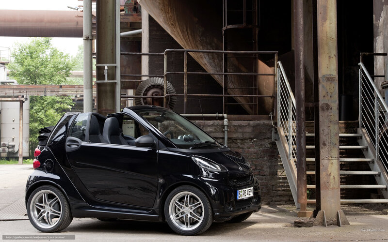 Black smart car in industrial setting