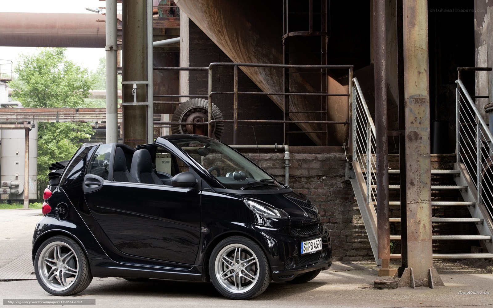 Black smart car in industrial setting