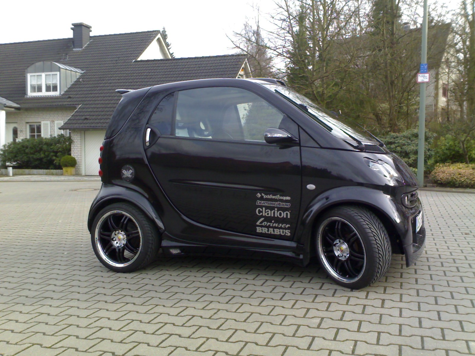 black smart car on driveway