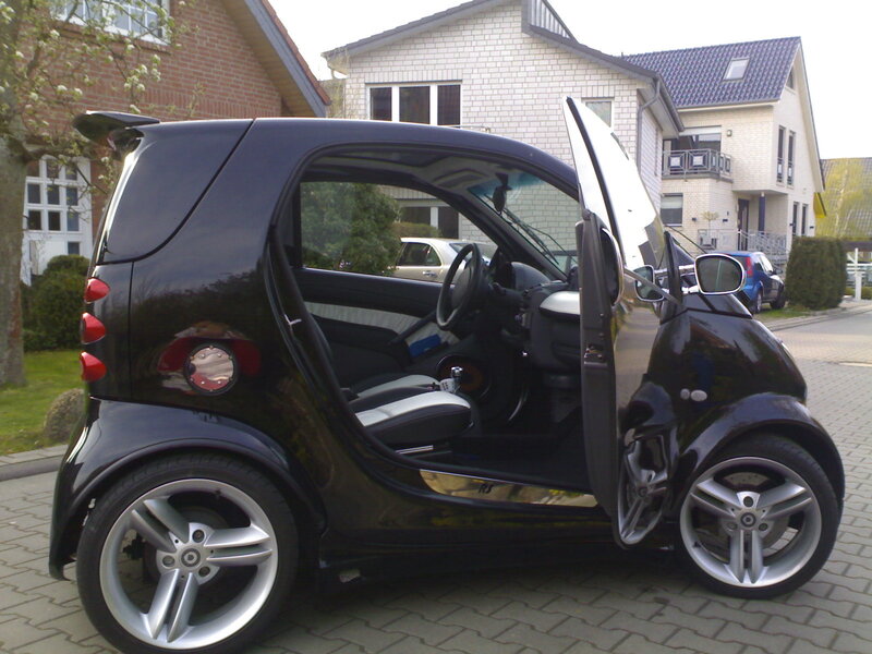 Black smart car with open door