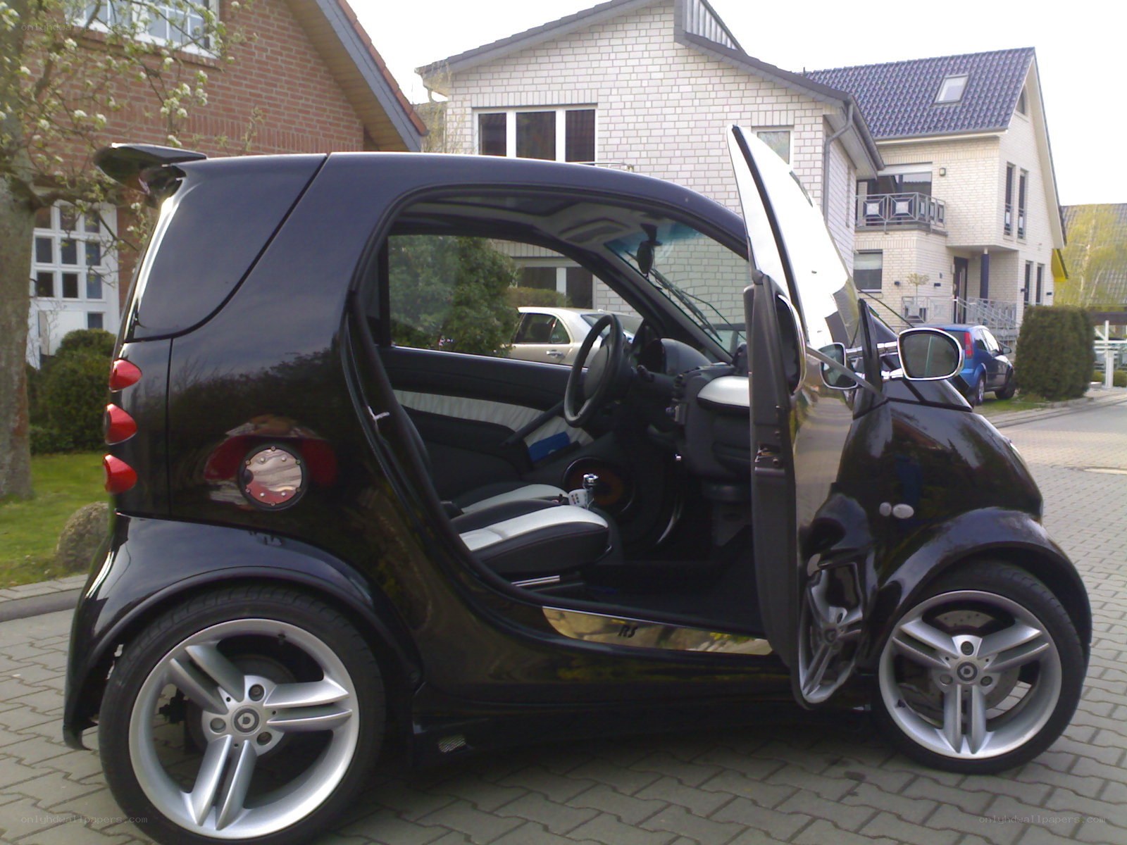 Black smart car with open door