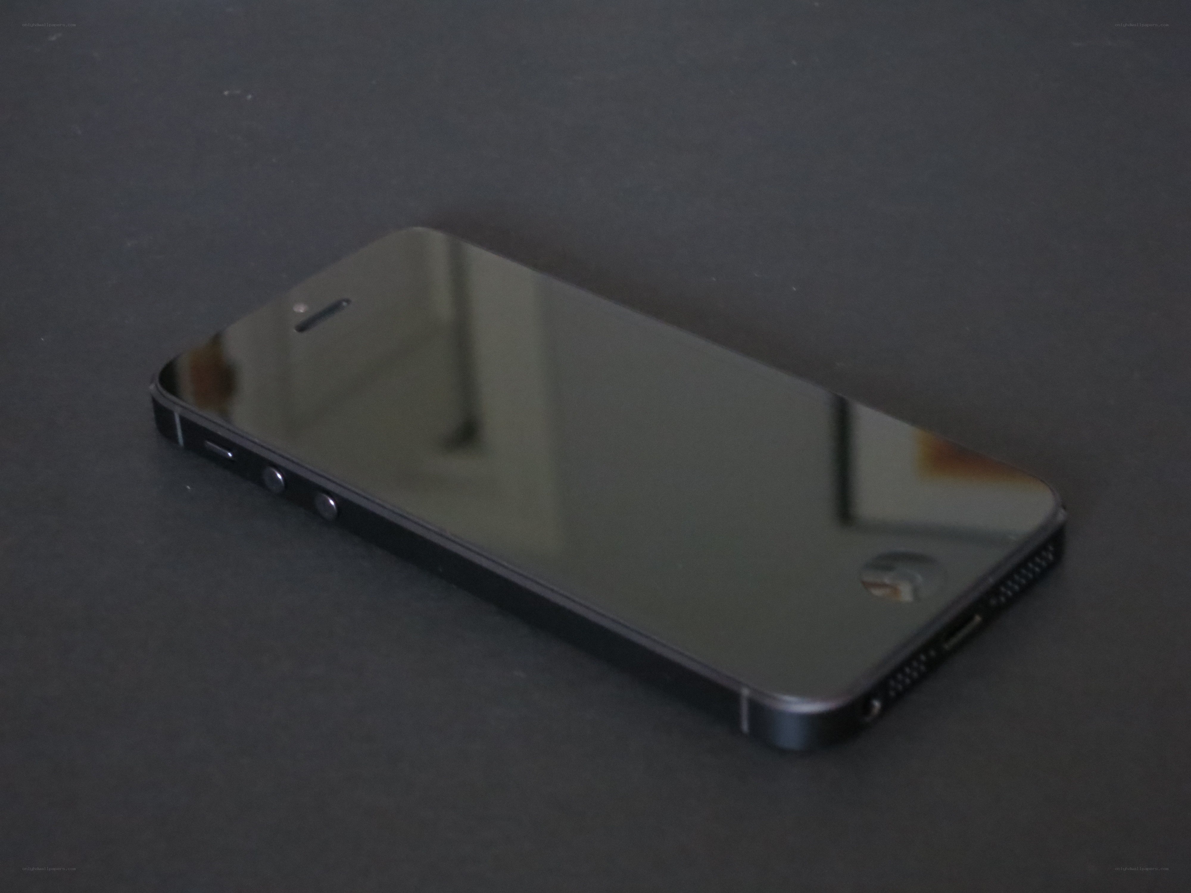 black smartphone on dark surface