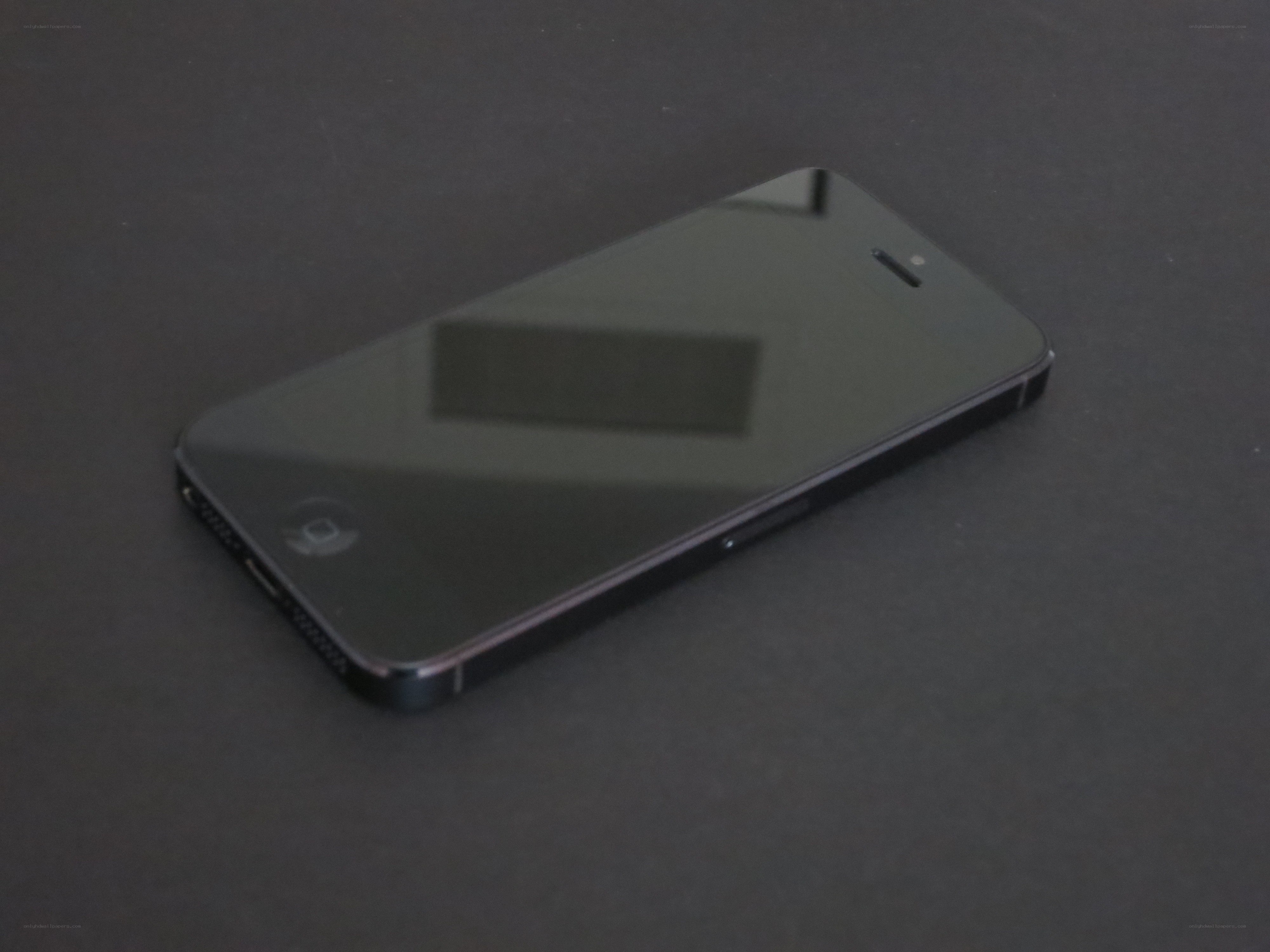black smartphone on dark surface