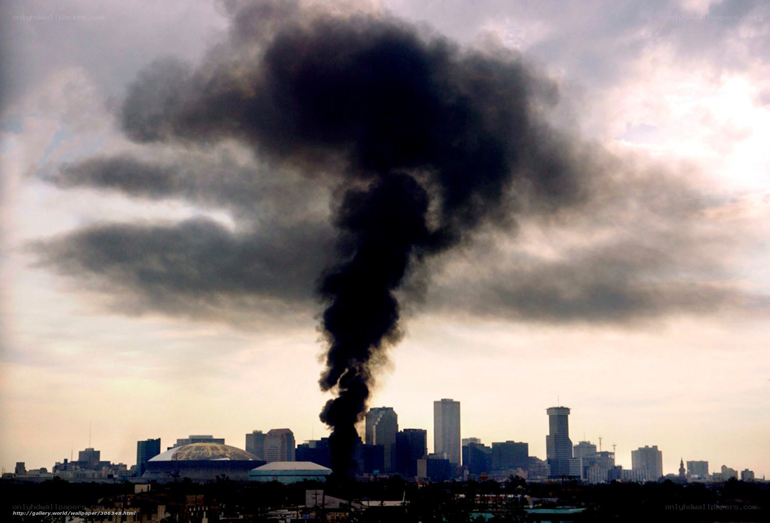 Black smoke over city skyline