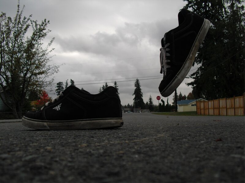 Black sneakers on a street