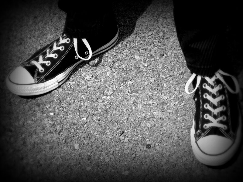 Black Sneakers on Pavement — Dramatic