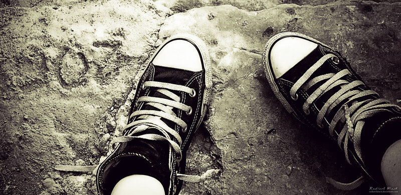 Black Sneakers on Stone