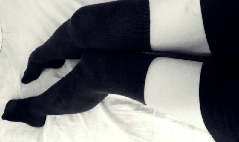 black socks on white bed
