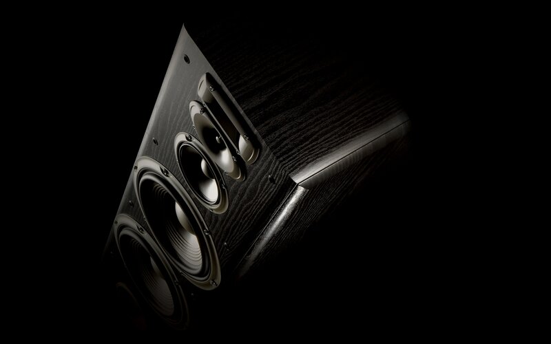black speaker with wood finish