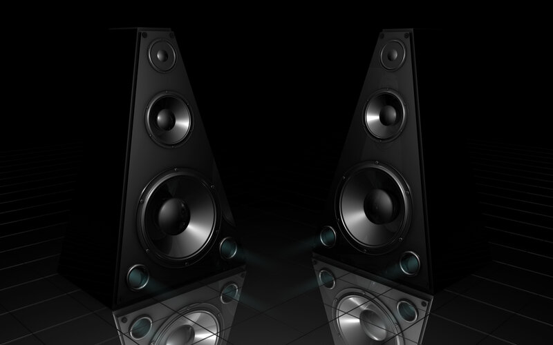 black speakers on dark floor