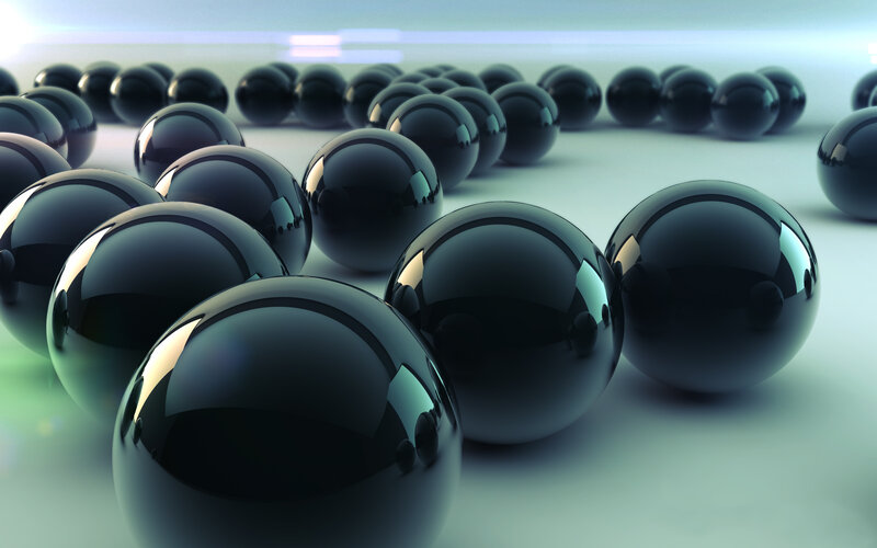 Black spheres on reflective surface