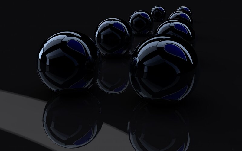 Black spheres on reflective surface
