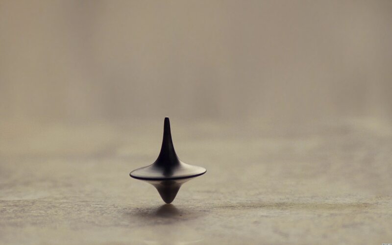 Black Spinning Top — Calm, Photograph