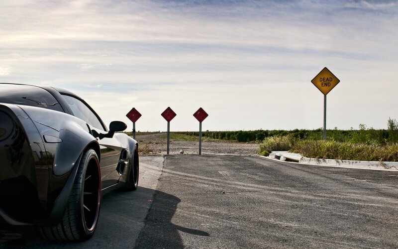 Black sports car at dead end