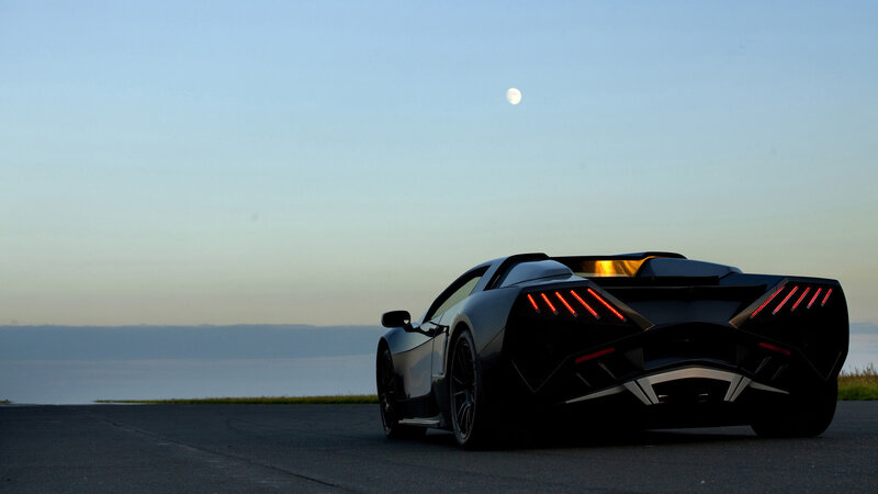 Black sports car at dusk