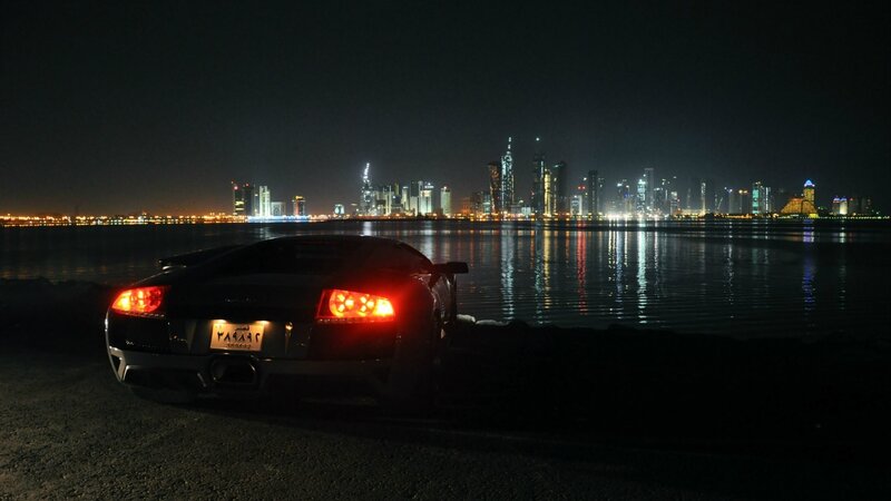 Black Sports Car at Night — Dramatic, Photograph, City Skyline, Water