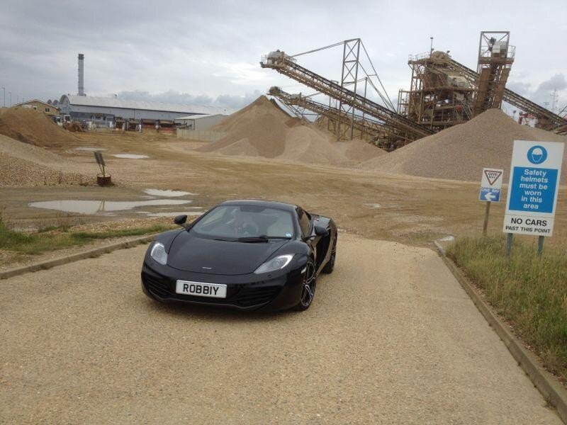 Black sports car at quarry site
