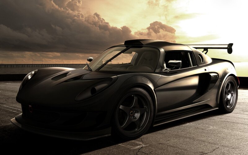 Black sports car at sunset