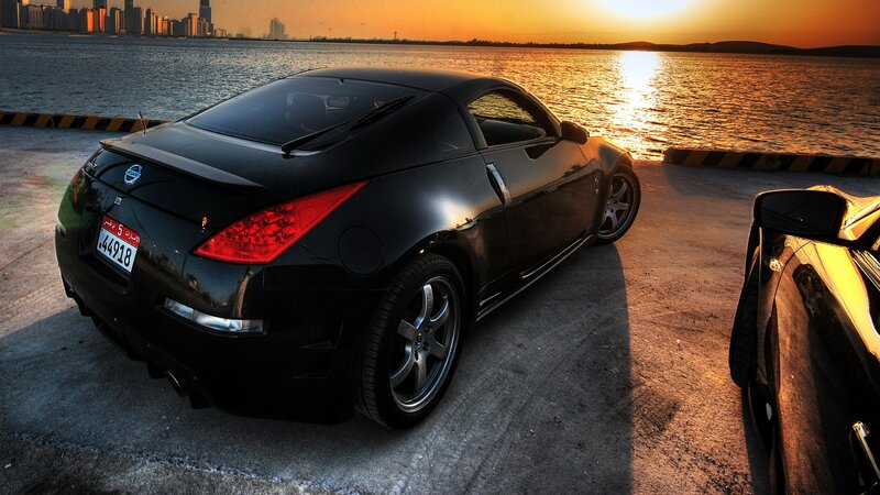 Black sports car at sunset