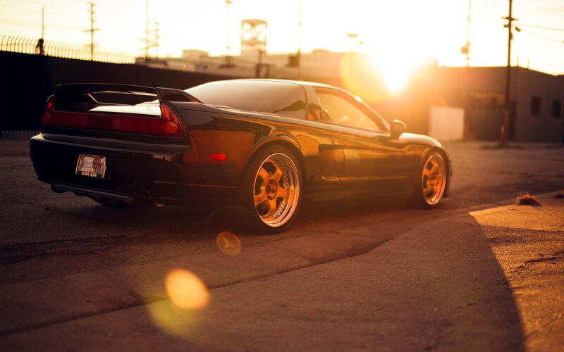 black sports car at sunset