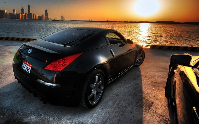 Black sports car at sunset