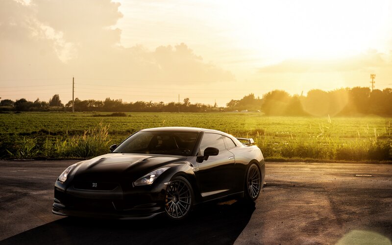 Black sports car at sunset