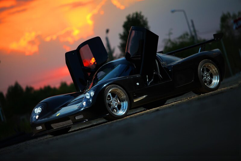Black sports car at sunset