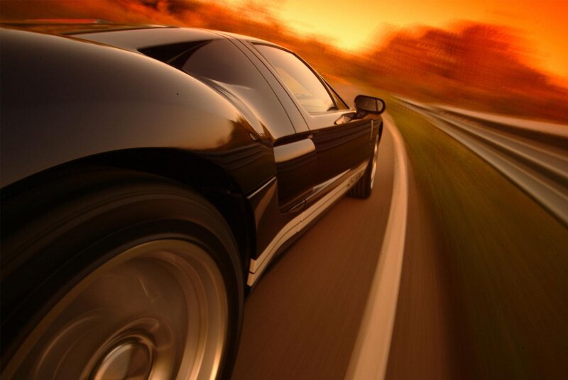 Black sports car at sunset