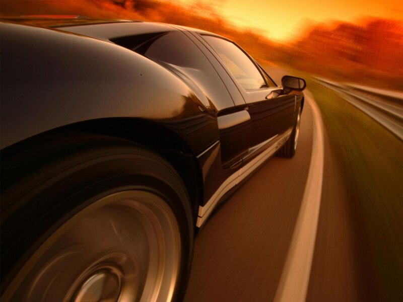 Black sports car at sunset
