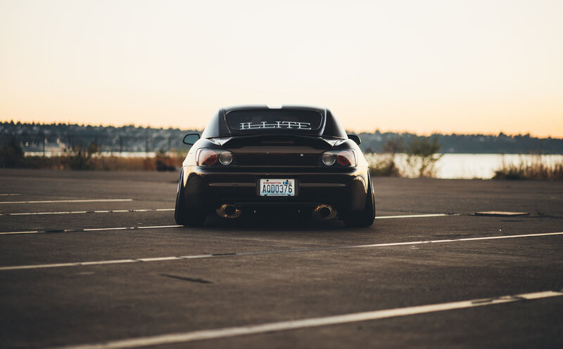 Black sports car at sunset