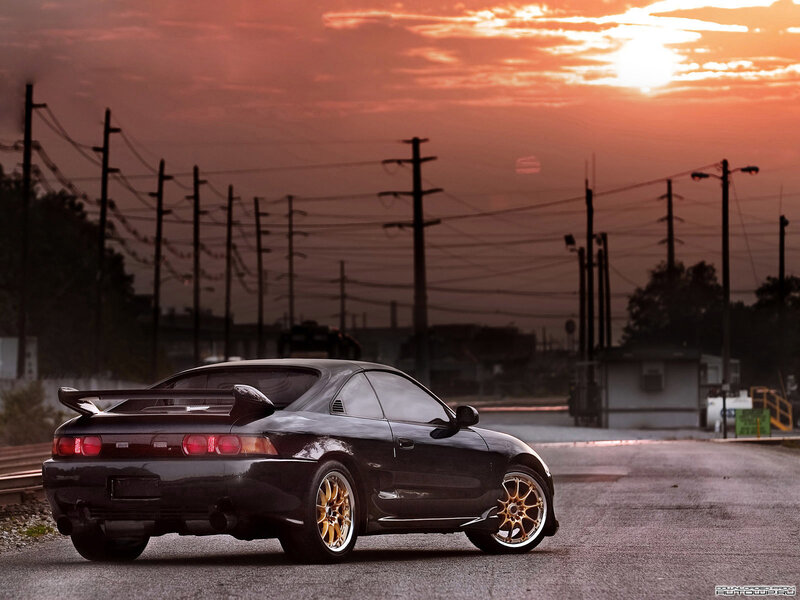 Black sports car at sunset