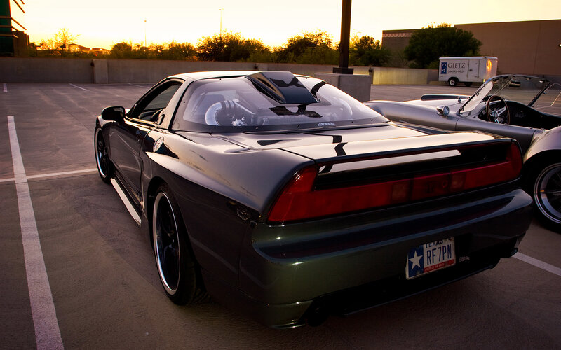 Black sports car at sunset