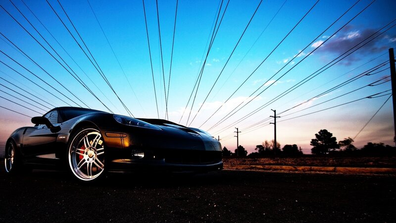 Black sports car at sunset