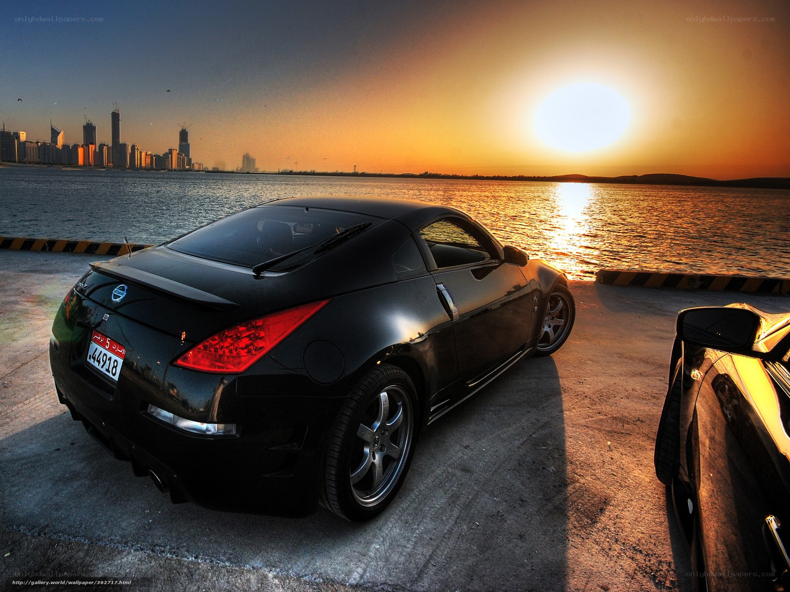 Black sports car at sunset