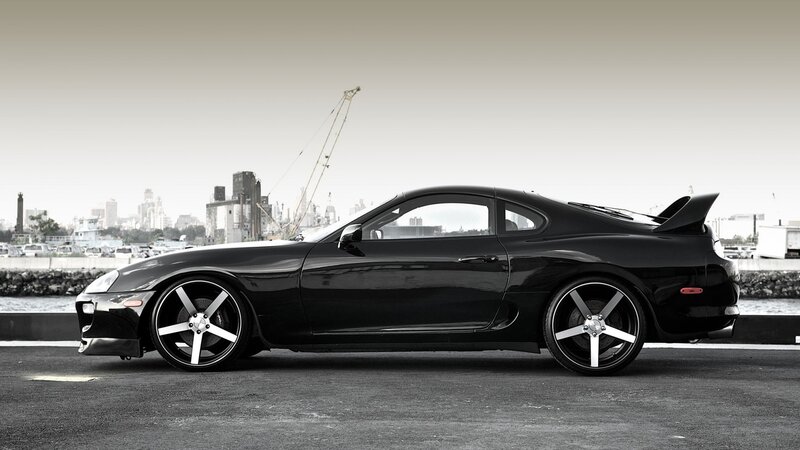 black sports car by the harbor