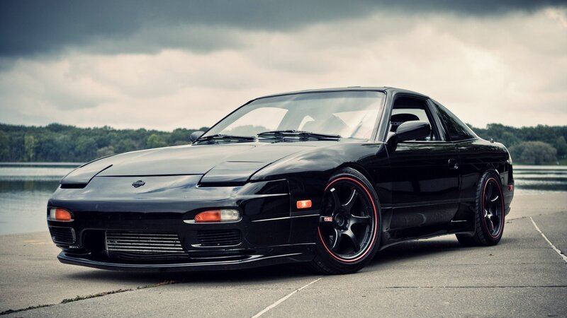 black sports car by the lake