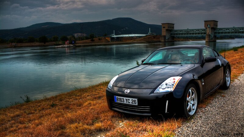 Black sports car by the river