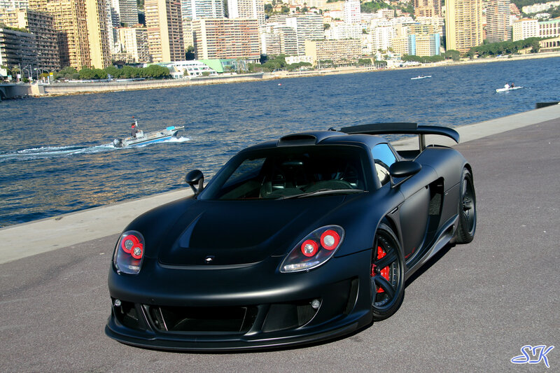Black sports car by the water
